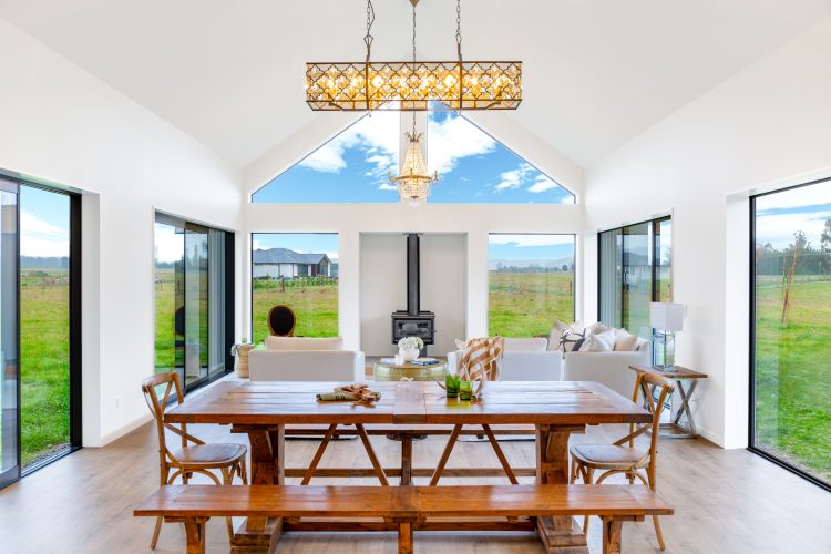 Architecturally designed rural home dining and living area with log burner cathedral ceiling Cust