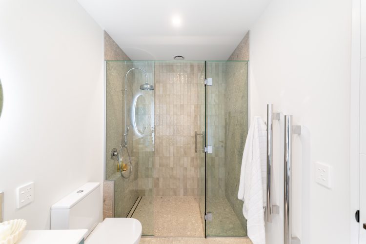 Architecturally designed rural home main bathroom fully tiled and glass shower Cust