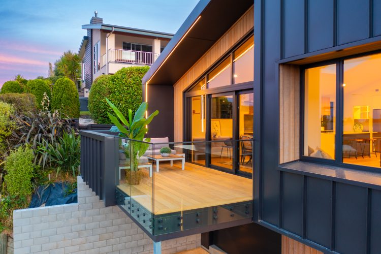 Architectural 2 storey passive SuperHome outdoor living area balcony built on steep hill slope Cashmere